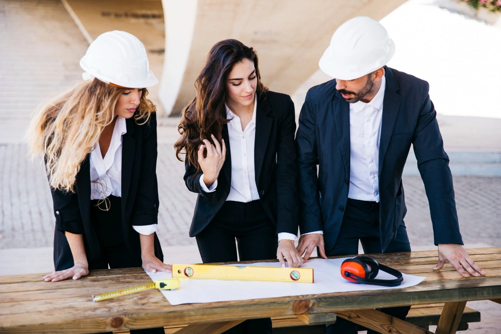 Professionals shaking hands at construction site over project agreement, highlighting digital marketing for construction companies